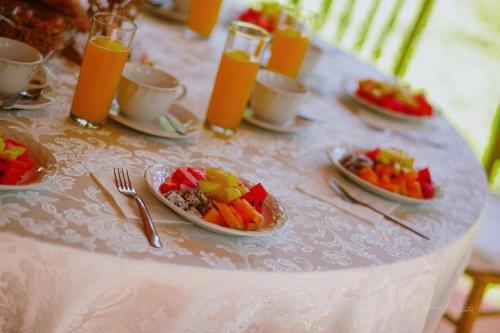 a white table with plates of food on it at El Encanto - Hotel Boutique in Chichén-Itzá