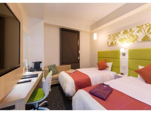 a hotel room with two beds and a desk at QUEEN'S HOTEL CHITOSE - Vacation STAY 67738v in Chitose
