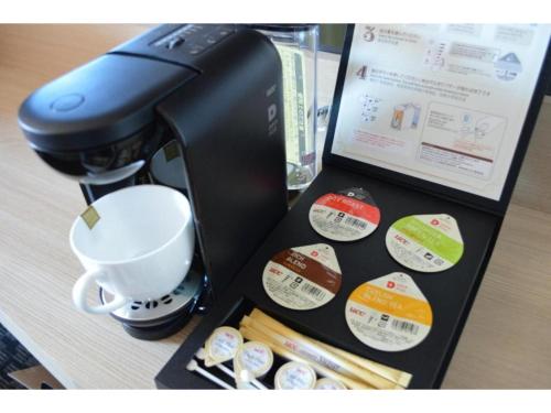 a coffee maker and a cup on a table at QUEEN'S HOTEL CHITOSE - Vacation STAY 67734v in Chitose