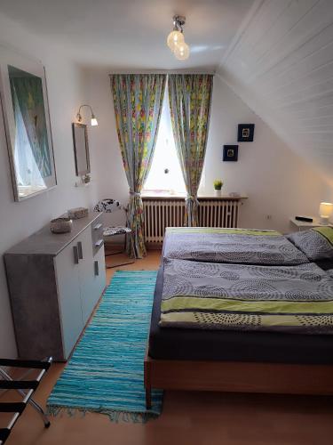 a bedroom with a large bed and a window at Haus Wander-Lust in Lauterbach