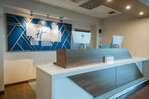 a reception desk in a dental office with a painting at Holiday Inn Express Hotel & Suites Tampa-Oldsmar, an IHG Hotel in Oldsmar