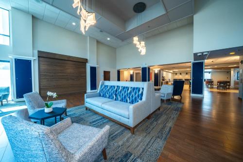 a lobby with a couch and chairs and a table at Holiday Inn Express Hotel & Suites Tampa-Oldsmar by IHG in Oldsmar