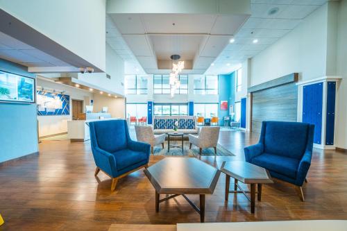 a lobby of a hospital with chairs and a table at Holiday Inn Express Hotel & Suites Tampa-Oldsmar by IHG in Oldsmar