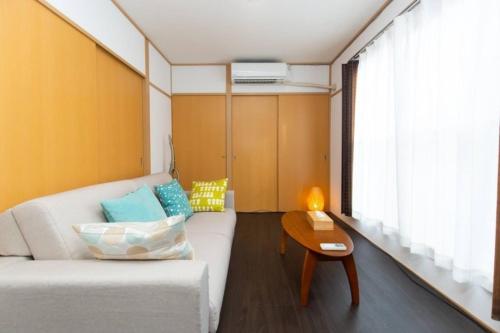 a living room with a couch and a table at Grace Heiwajima - Vacation STAY 15088 in Tokyo