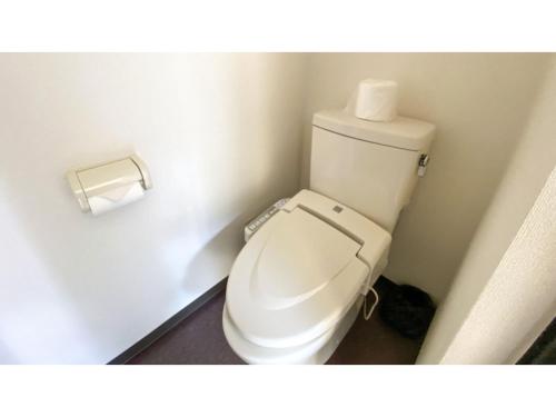 a toilet in a bathroom with a roll of toilet paper at Forte "Hachijojima" - Vacation STAY 62466v in Hachijo
