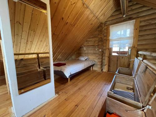 a room with a bed in a wooden cabin at Nuustakumajad in Otepää