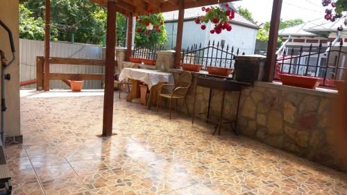 a patio with a table and chairs on a floor at CASA ADELA in Tulcea