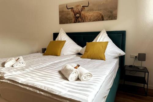 a bed with two towels and a bull on it at cameiroo - Apartment Euskirchen in Euskirchen