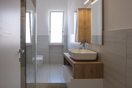 a bathroom with a sink and a toilet at Un posto al sole in Monopoli