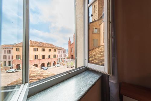 a window with a view of a city street at Palazzo Ciravegna in Alba