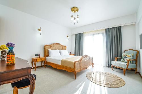 a bedroom with a bed and a desk and a piano at LinAsya Bozcaada in Çanakkale