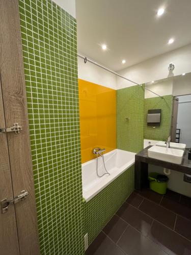 a bathroom with a bath tub and a sink at B38 Apartment in Budapest