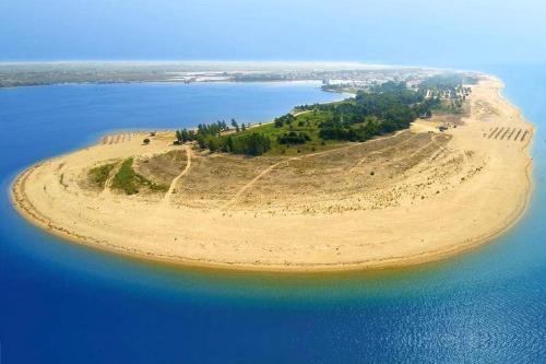 an island in the middle of a body of water at AEGEAN SUITES in Keramotí