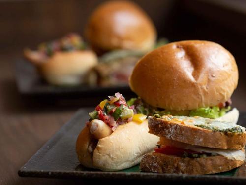 a sandwich on a black plate with a sandwichsemblyomaly at Iseebiso - Vacation STAY 69529v in Ei