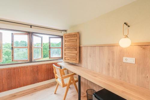 a home office with a wooden desk and windows at Hotel BESTPRICE Santillana in Santillana del Mar