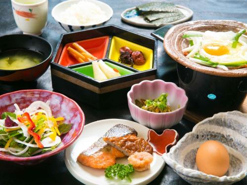 a table with plates of food and bowls of food at Iseebiso - Vacation STAY 69522v in Ei