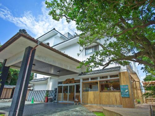 a white house with a porch and a building at Iseebiso - Vacation STAY 69481v in Ei