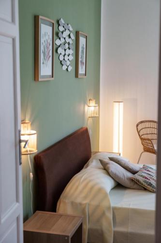 a bedroom with a bed with a table and pictures on the wall at Le Vele Mondello, villa a due passi dal mare in Mondello