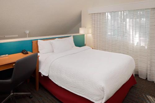 a hotel room with a bed and a desk and a bed sidx sidx at Residence Inn Binghamton in Vestal