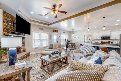 a living room with couches and a ceiling fan at The Blue Canoe in Crestview