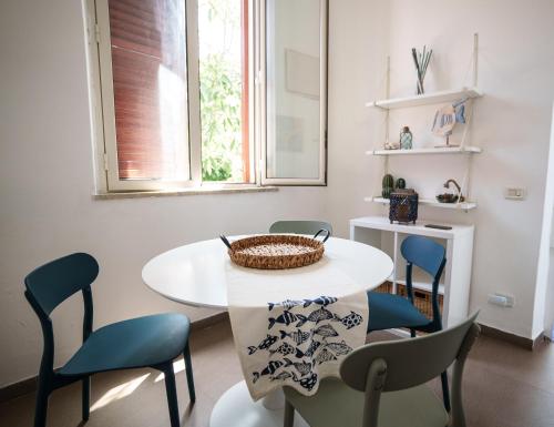 a dining room with a white table and chairs at Le Vele Mondello, villa a due passi dal mare in Mondello