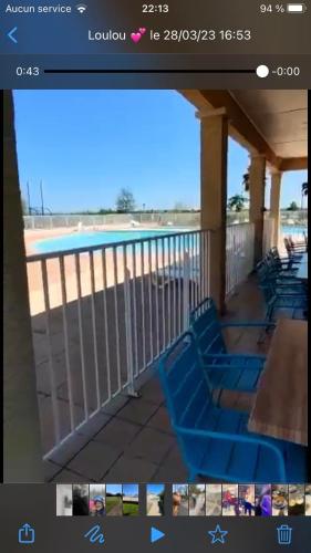 a picture of a balcony with blue chairs on a porch at Résidence Les Berges du Canal in Béziers