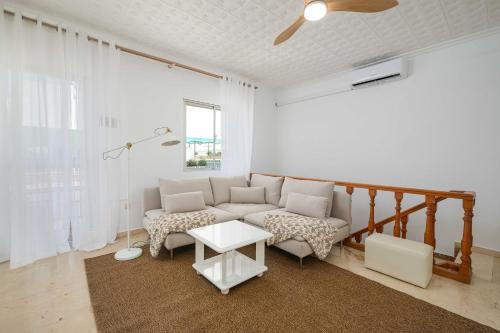 a living room with a couch and a table at Andalucian house, few minutes from the beach in Fuengirola
