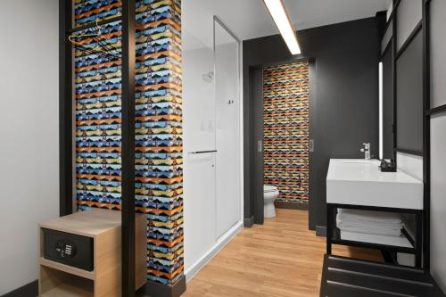 a bathroom with a large wall of towels at Aloft Kansas City Country Club Plaza in Kansas City