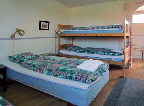 2 Etagenbetten in einem Zimmer mit einer Lampe in der Unterkunft Fleninge Classic Motel in Fleninge