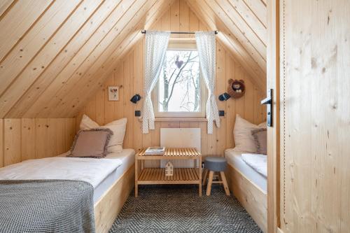 a bedroom with two beds in a wooden cabin at Stylowa Chata in Zakopane
