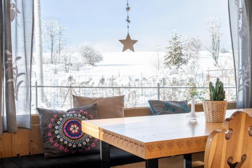 a dining room with a table and a large window at Stylowa Chata in Zakopane