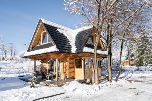 a log cabin with snow on the roof at Stylowa Chata in Zakopane
