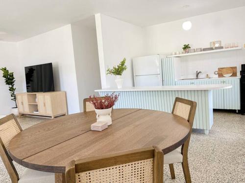 a wooden table with chairs and a vase on it at Casa Eve near Gozalandia Waterfalls in San Sebastian