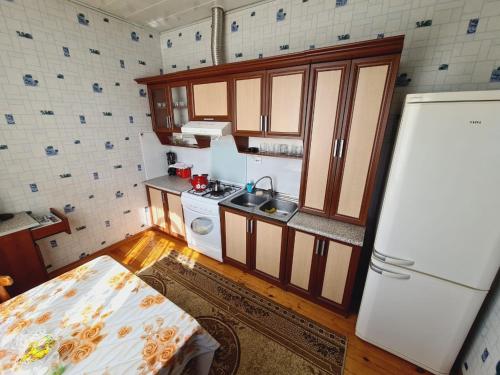 a small kitchen with a sink and a refrigerator at Green garden Zargan villa in Gabala