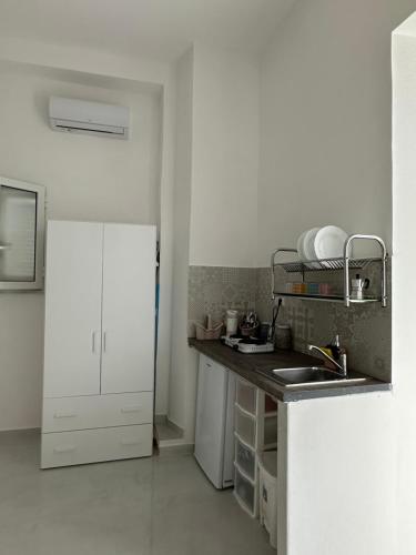 a kitchen with a sink and a counter top at O’Vascio e maruzzella in Naples
