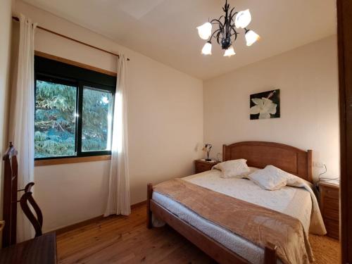 1 dormitorio con cama y ventana en Ás Portas do Sil - En la Ribeira Sacra, 