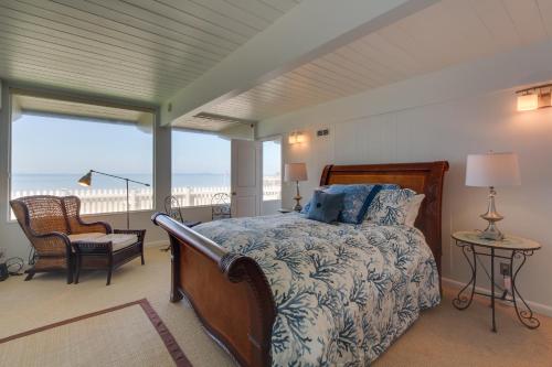 a bedroom with a bed and a view of the beach at West Beach Retreat in Oak Harbor