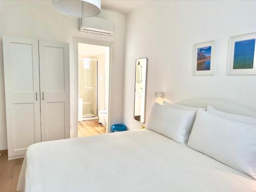 a white bedroom with a large white bed at B&B Cellini in Santa Maria di Castellabate