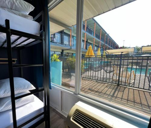 a room with two bunk beds and a pool at Bposhtels Houston in Houston