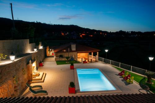 a swimming pool in the middle of a patio at Casa do Sabugueiro in Ponte de Lima