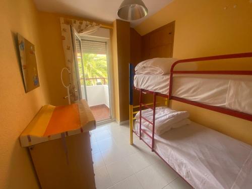 a small room with two bunk beds and a window at El mirador de mogro in Mogro