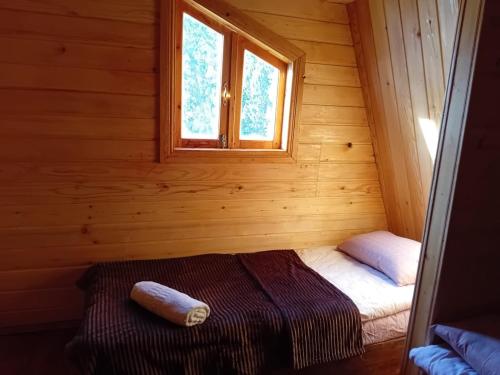 Habitación pequeña con 1 cama en una cabaña de madera en Wooden House in Tsvirmi en Tsvirmi