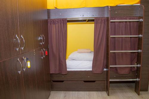 a small room with a bunk bed in a room at Sun City Hostel 4 in Kyiv