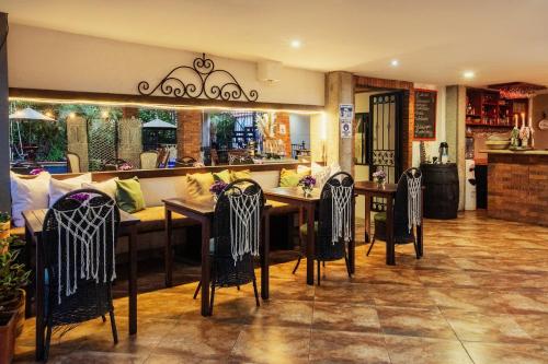 a restaurant with a long table and chairs at Hotel El Ancla in La Vega