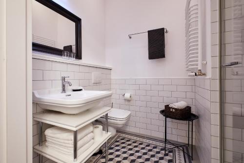 a white bathroom with a sink and a toilet at Nice apartment in Old Town 2 in Krakow