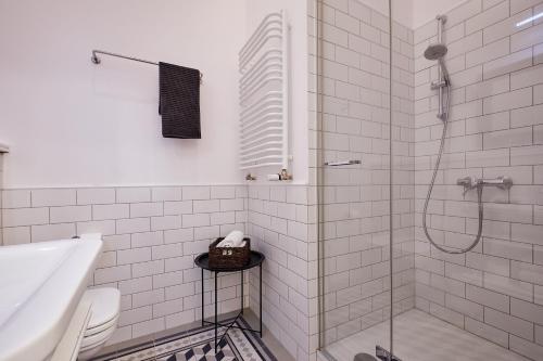 a white bathroom with a shower and a sink at Nice apartment in Old Town 2 in Krakow