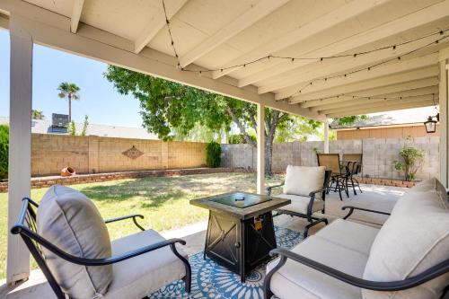 a screened in porch with chairs and a wood stove at Dog-Friendly Yard! North Phoenix Family Retreat in Phoenix