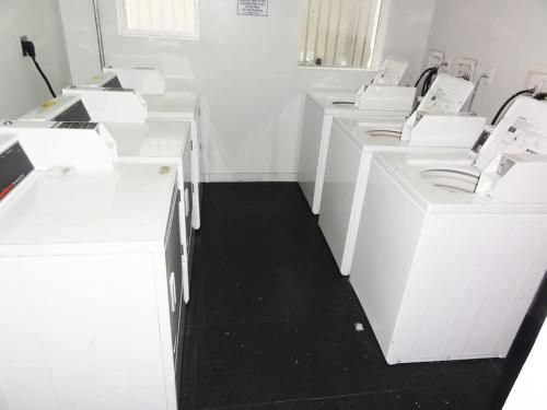 a white room with white cabinets and a black floor at South Beach Paradise: best of Miami in Miami Beach