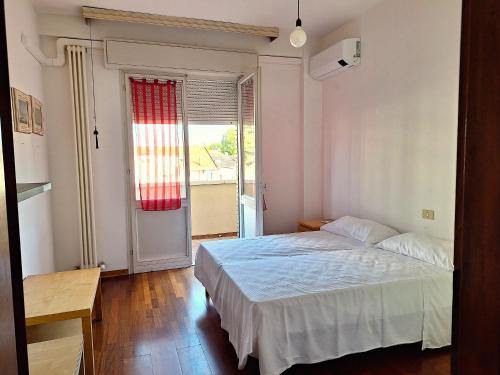 a bedroom with a bed and a large window at Appartamento 150 mq vicino al mare in Cattolica