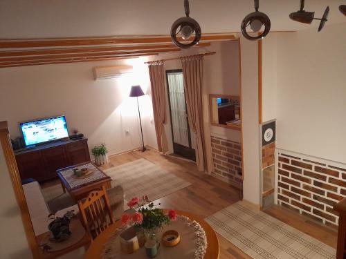 a living room with a table and a television at Bajka in Valjevo